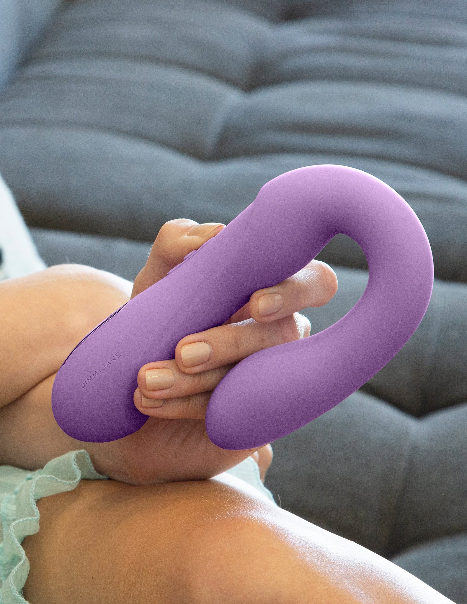 Woman holding the Rabbit Reflexx Vibrator purple color