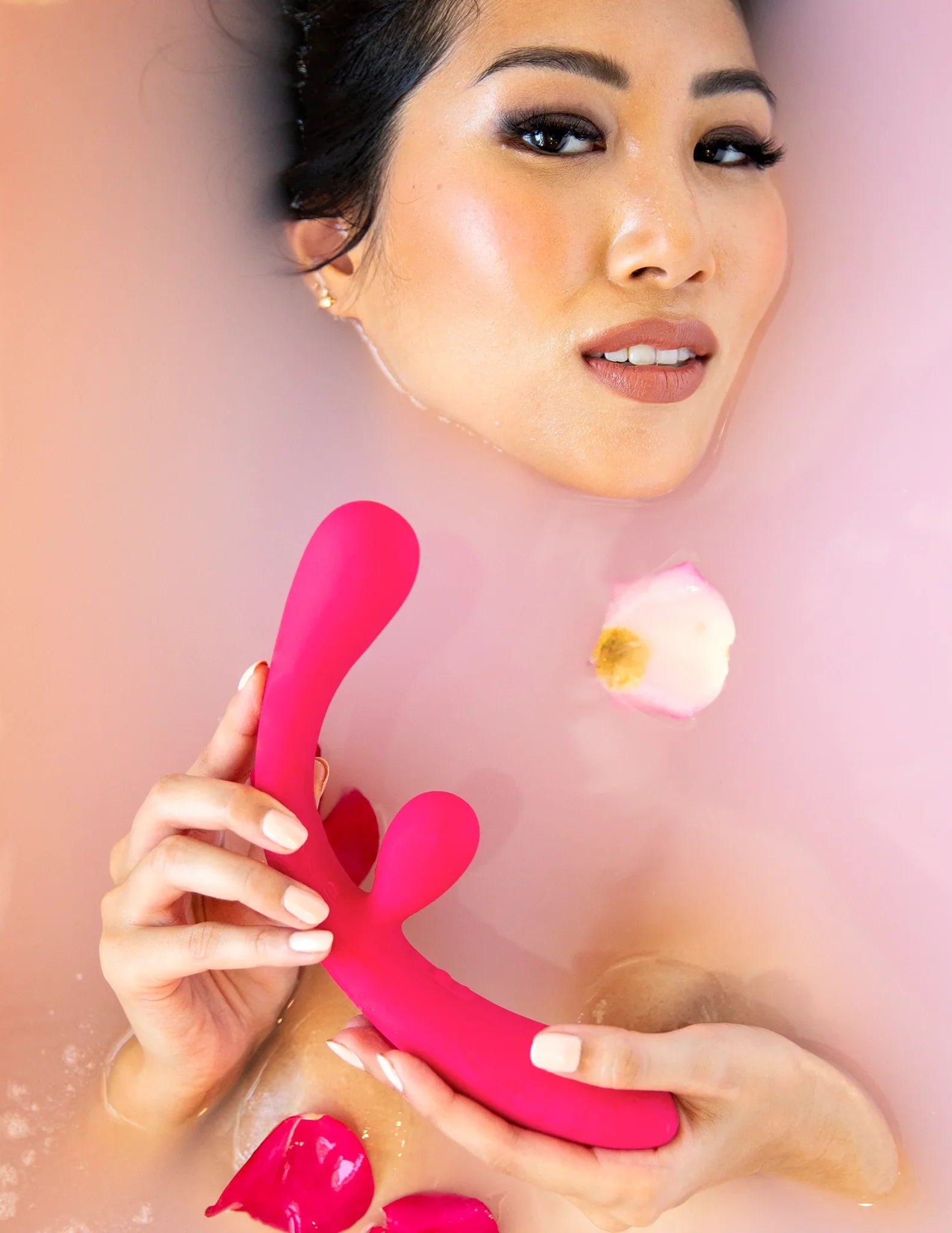 Asian woman model holding the Rabbit Vibrator Pink Color Reflexx 3 