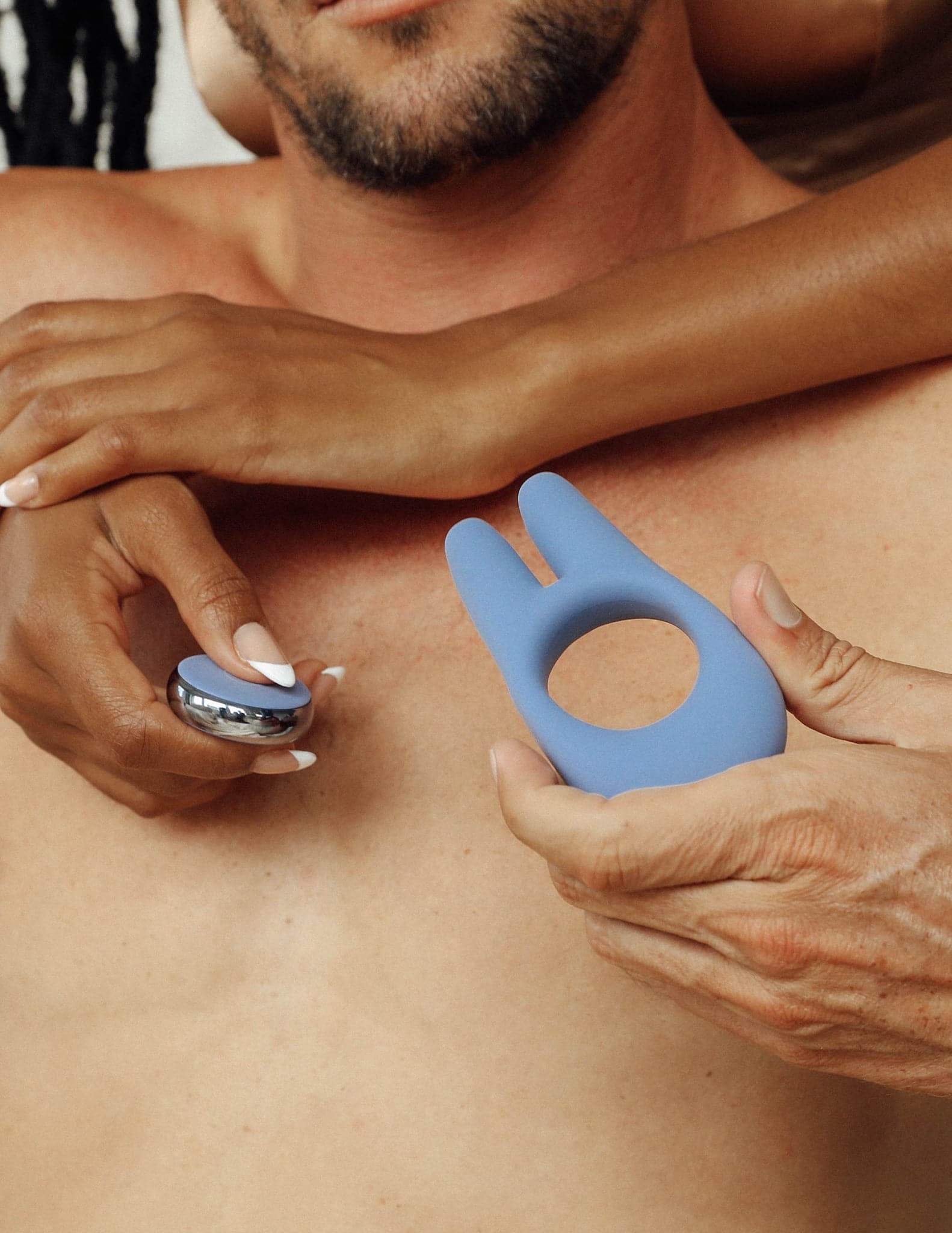 Couple holding the remote control silicone penis ring with two prong rabbit ears 
